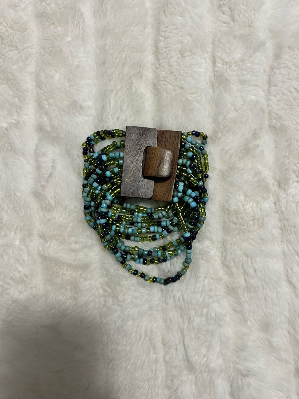Blue/green beaded bracelet with wooden clasp